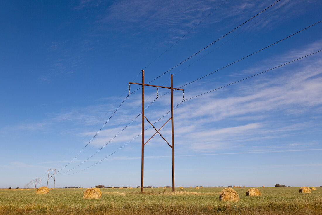 Landscape view of power pole and straw bales on Highway 15,  Saskatchewan, Canada