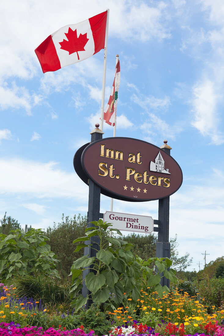 Canadian flag on sign board of The Inn at St. Peters, Prince Edward Island, Canada 