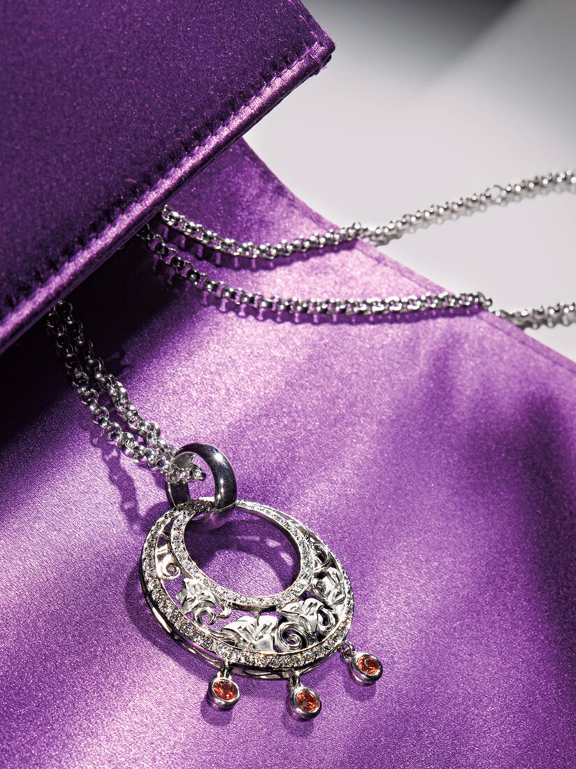 Close-up of necklace on purple background