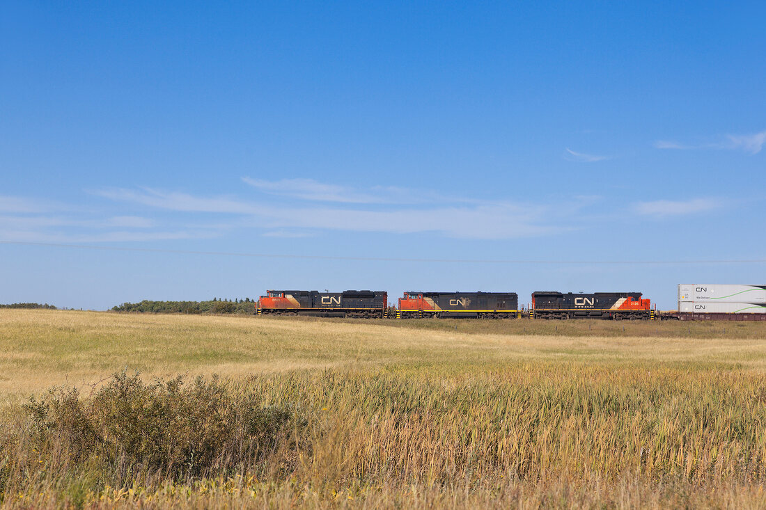 View of train and landscape along Highway 15, Saskatchewan, Canada,
