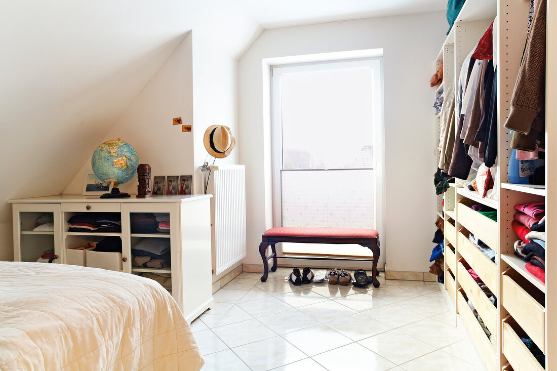 Bedroom with closet, open drawers and globe