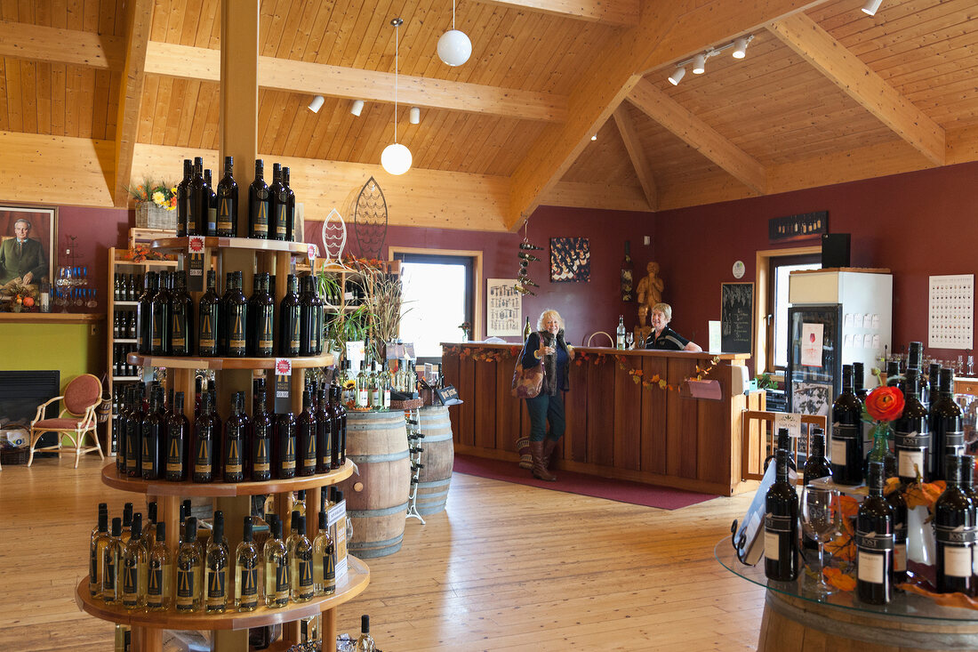 View of women at counter and different wines on shelf, Nova Scotia, Canada
