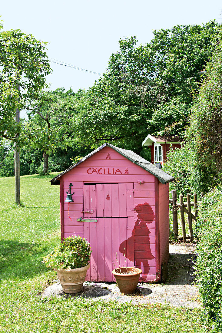 Pink garden shed, playhouse and gazebo in garden