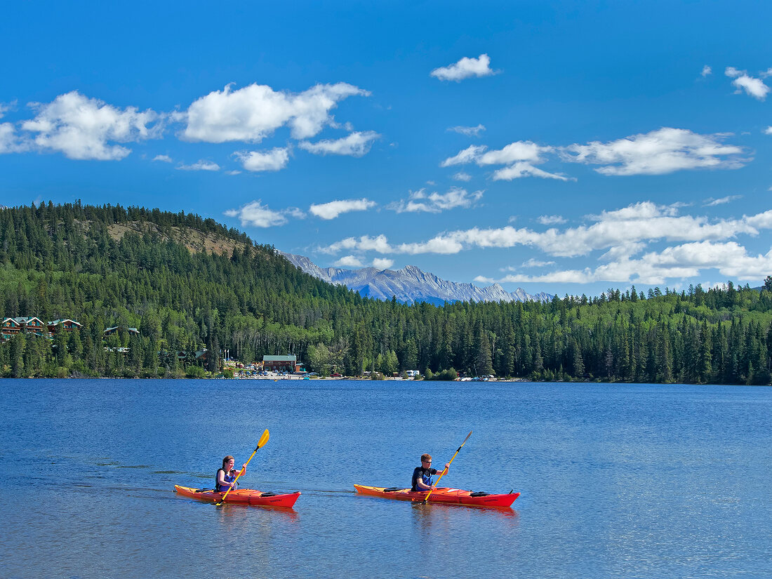 People in boats using kayaking at Pyramid Lake, Jasper National Park, Alberta, Canada