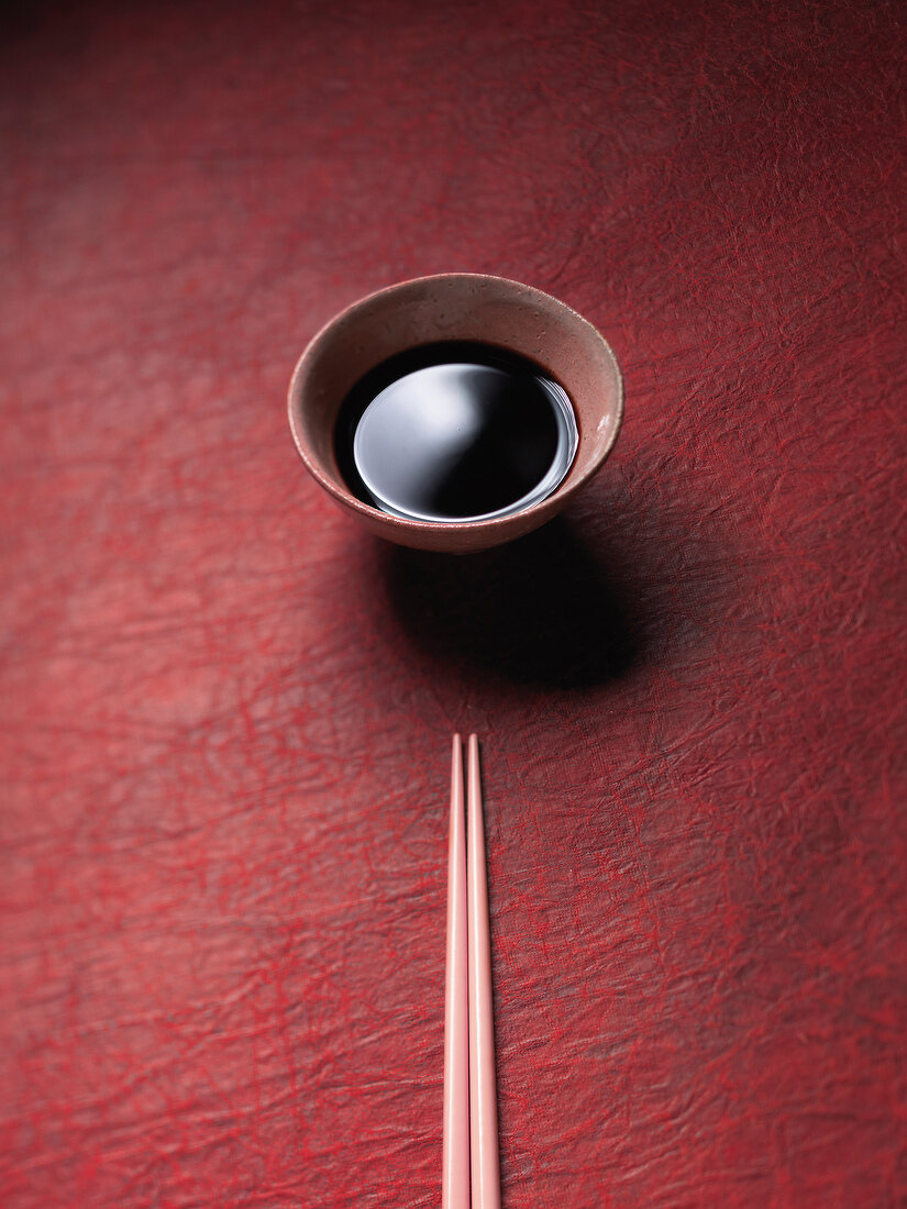 Soy sauce in bowl with chopsticks