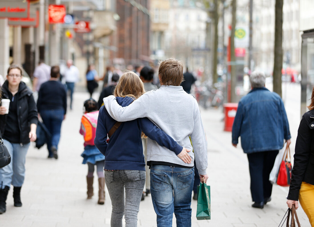 Rear view of couple walking on street