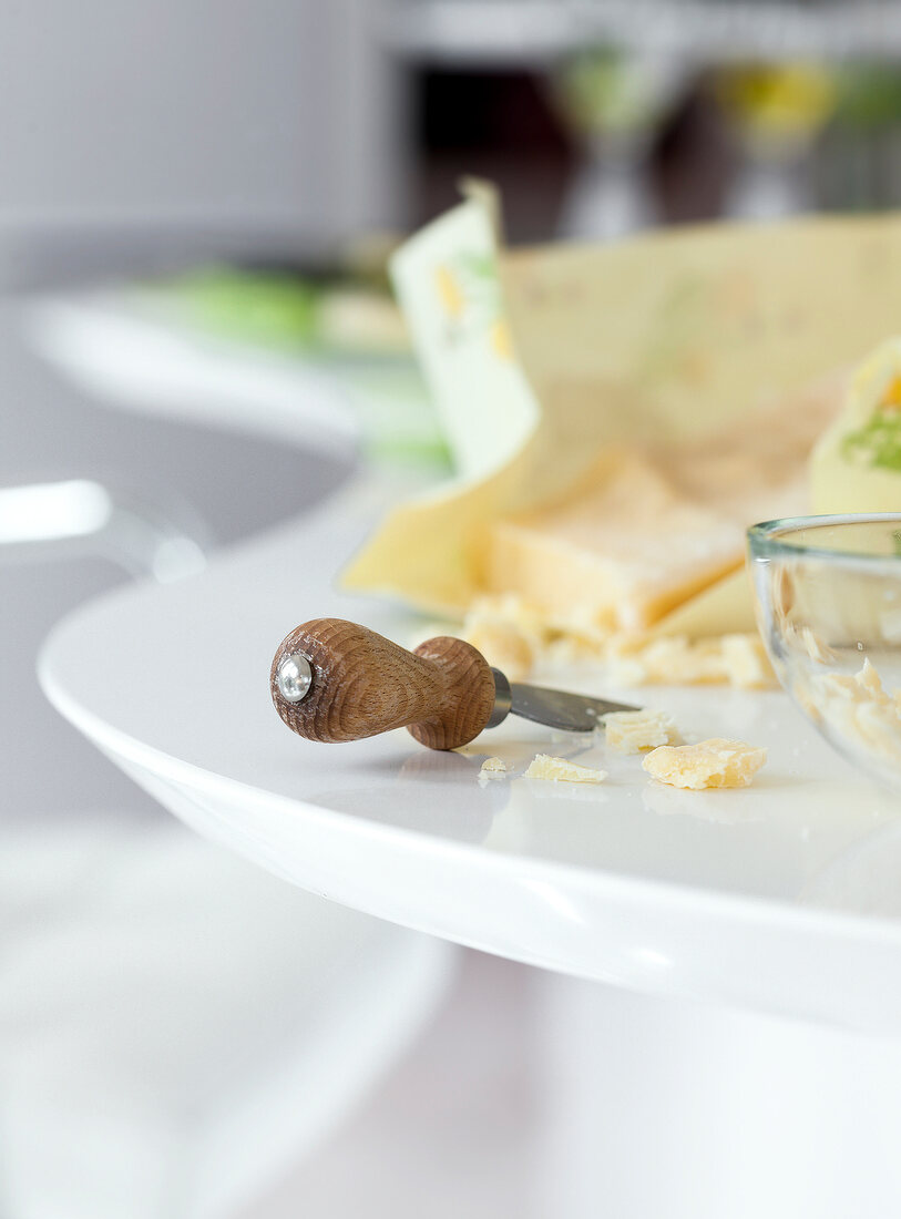 Cheese with cheese knife on table