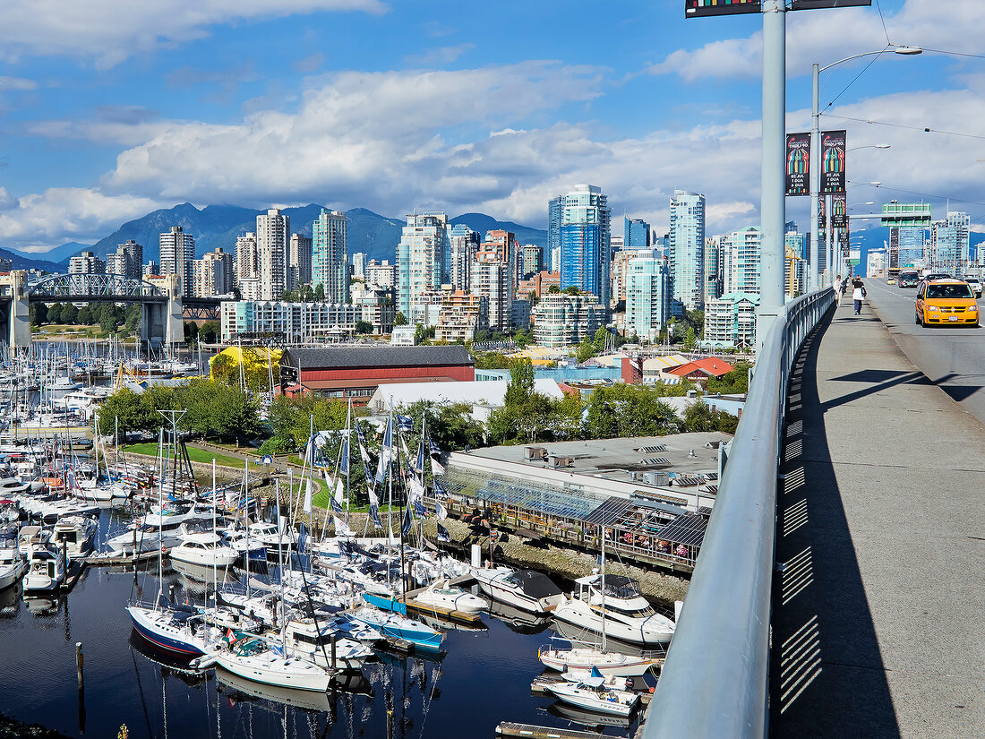 Three women walking on Granville Street Bridge in False Creek, Vancouver, Canada