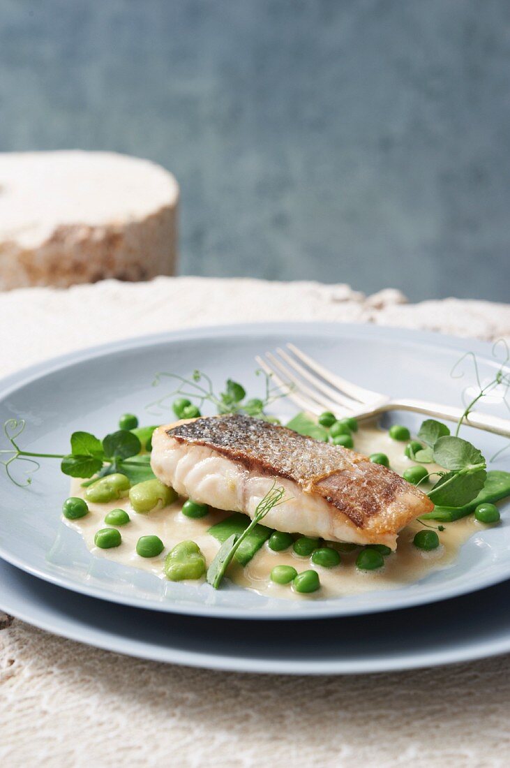 Seabass with an olive oil broth, peas and mange tout