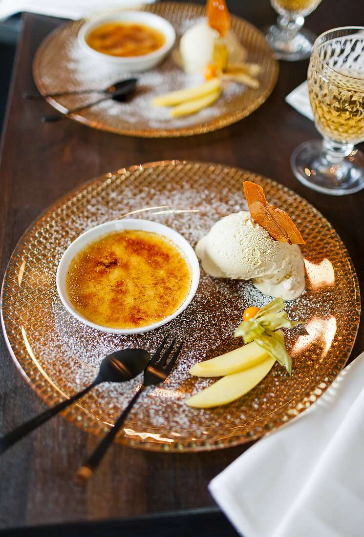 Creme brulee with vanilla ice cream on plate