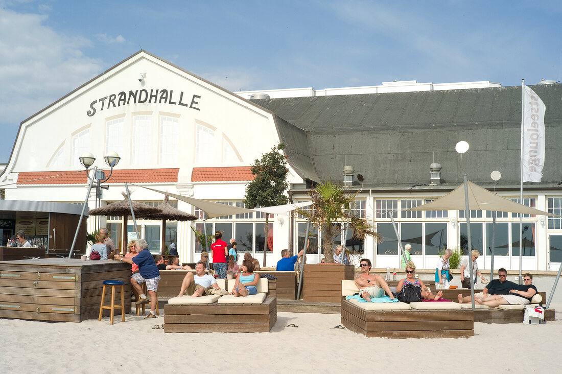 People relaxing near Strandhalle Restaurant, Bay of Lubeck, Schleswig Holstein, Germany