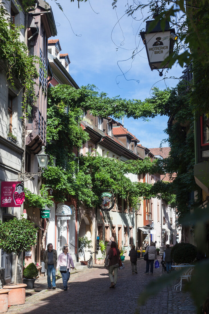 People walking on Konvikt street in the old town, Freiburg, Germany