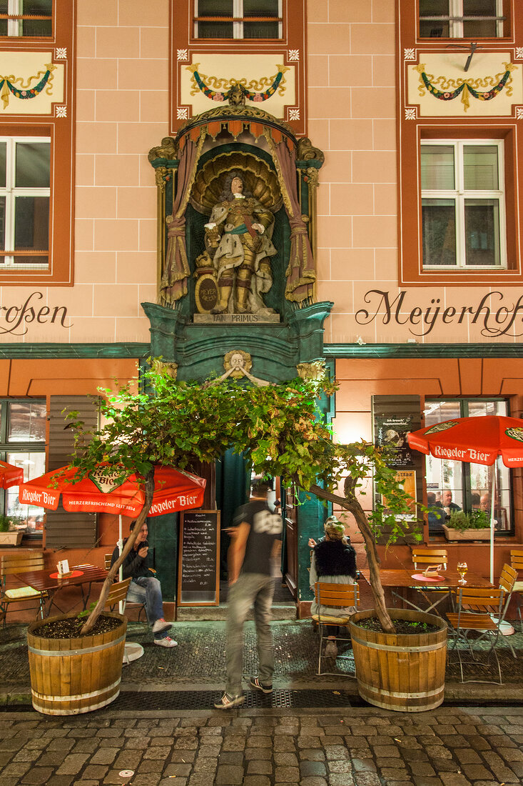 Entrance of tavern Big Meyerhof in Old Town Freiburg, Germany, blurred motion