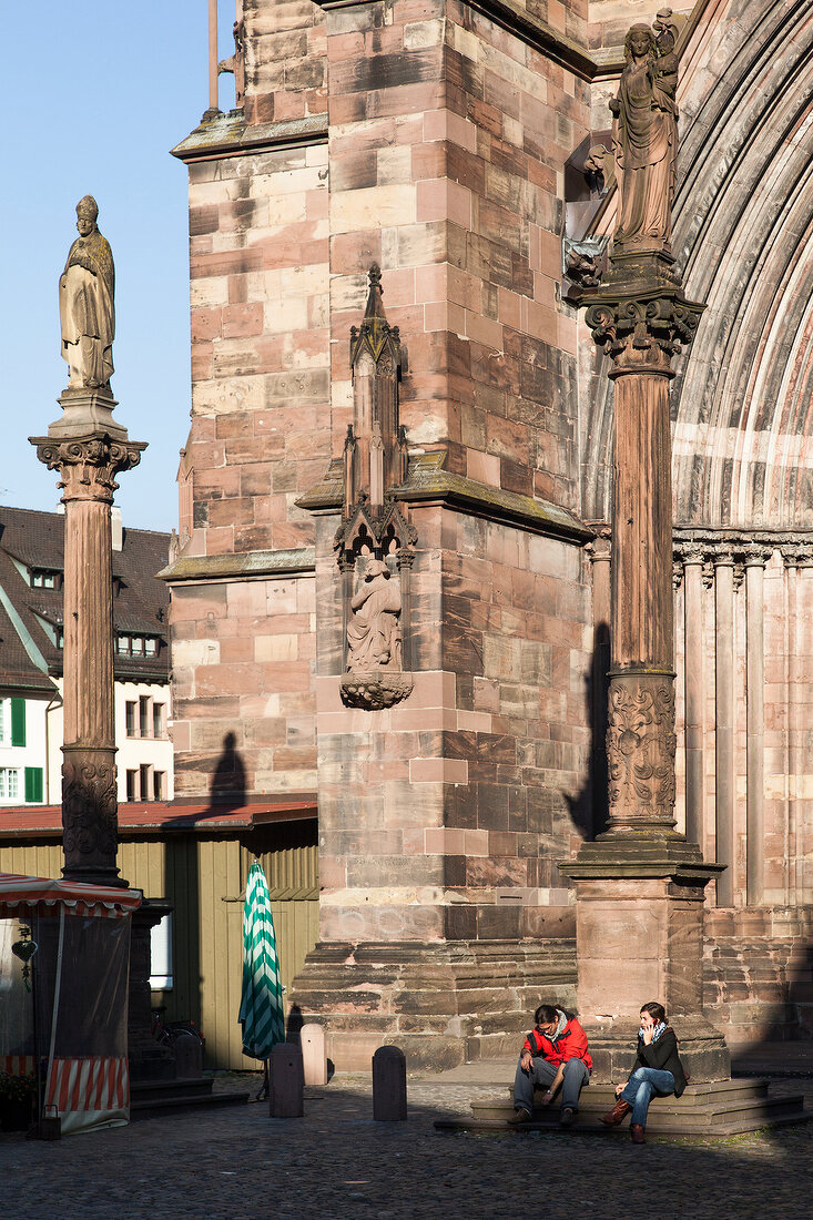 Two women sitting outside Freiburg Minster, Germany