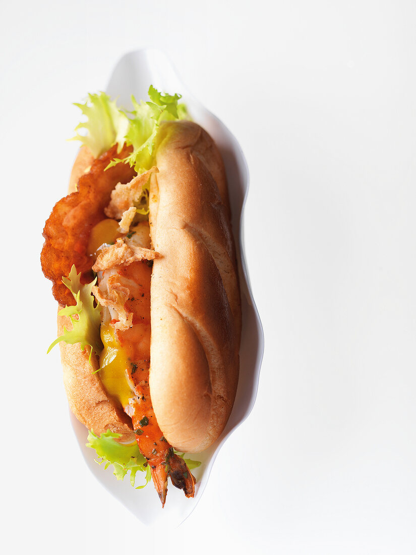 Close-up of hotdog with king prawn on plate