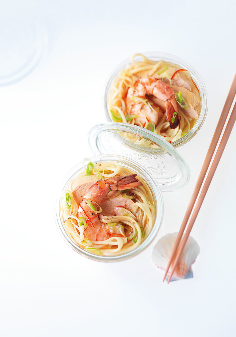 Asian noodle soup with shrimp and chicken in mason jars