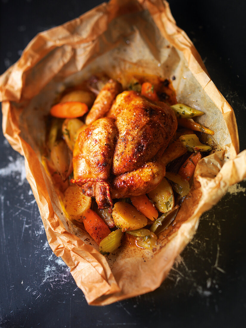 Roasted chicken with vegetables in baking paper