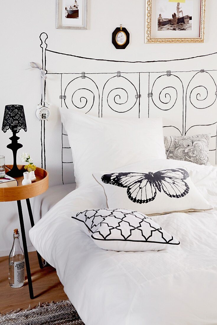 Bed with headboard painted on wall & scatter cushions
