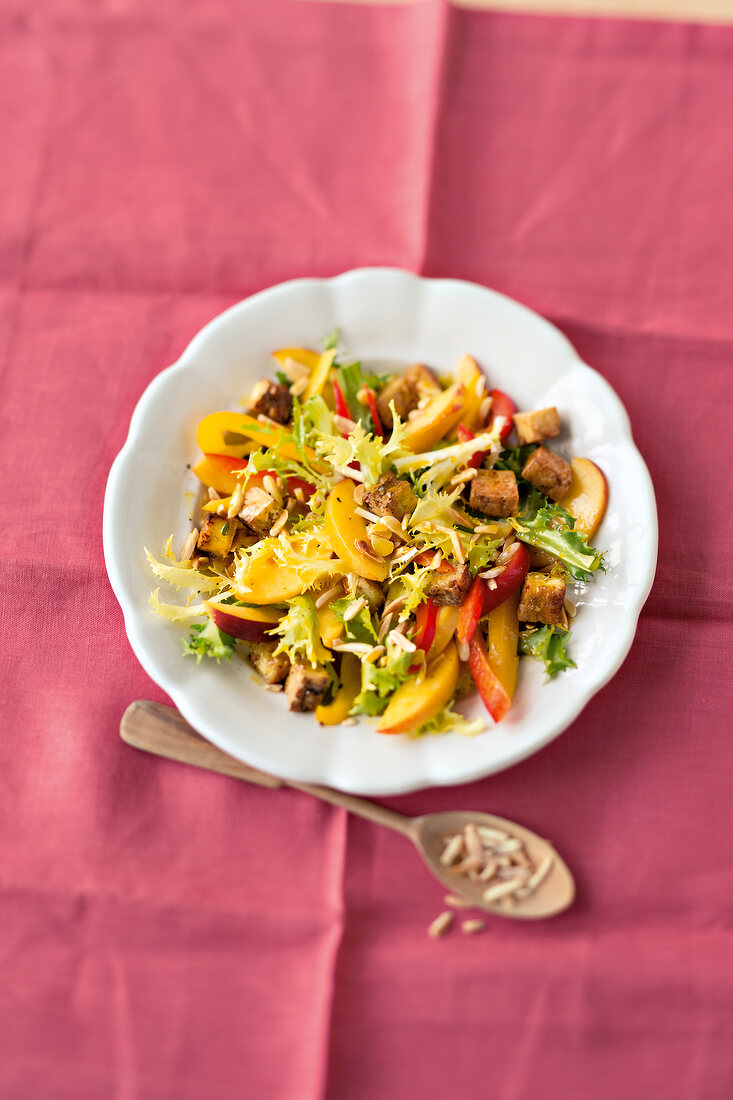 Paprika peach salad with nuss tofu on plate