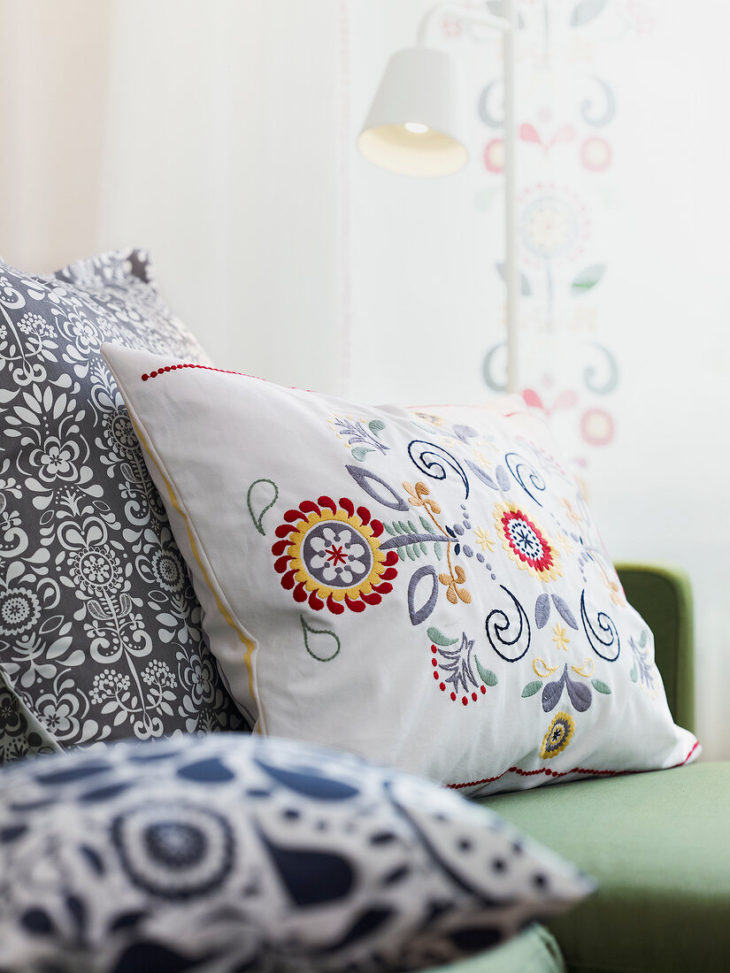 Cushions with embroidered flower motifs