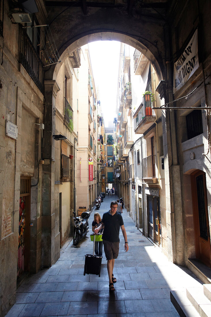 View of tourist with luggage at residents in Placa Reial, Barcelona, Spain