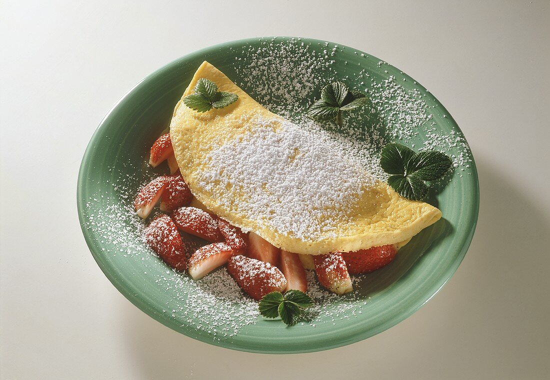 Strawberry omelette with icing sugar