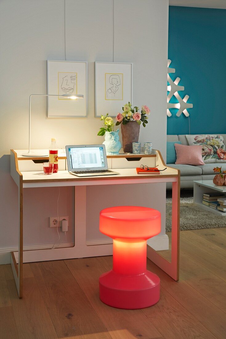 A desk with an illuminated stool