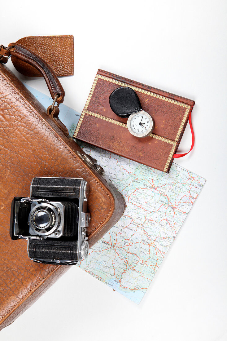 Diary, camera, briefcase and map for travel on white background