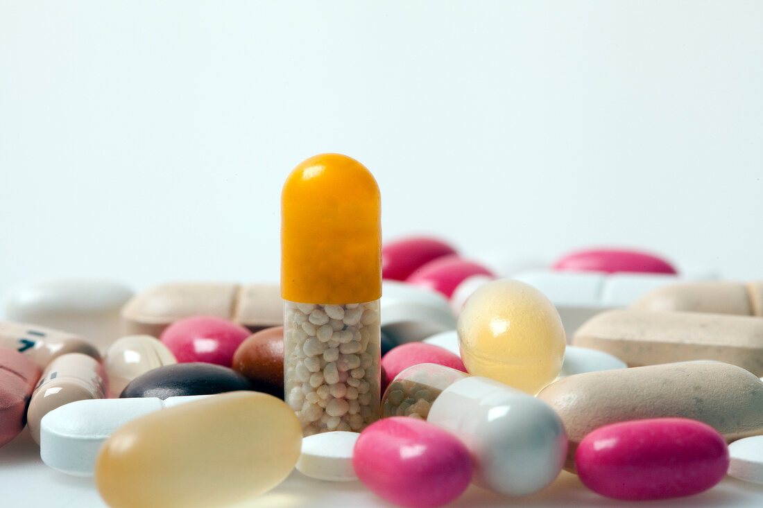 Close-up of different pills, tablets, dragees and capsules on white background