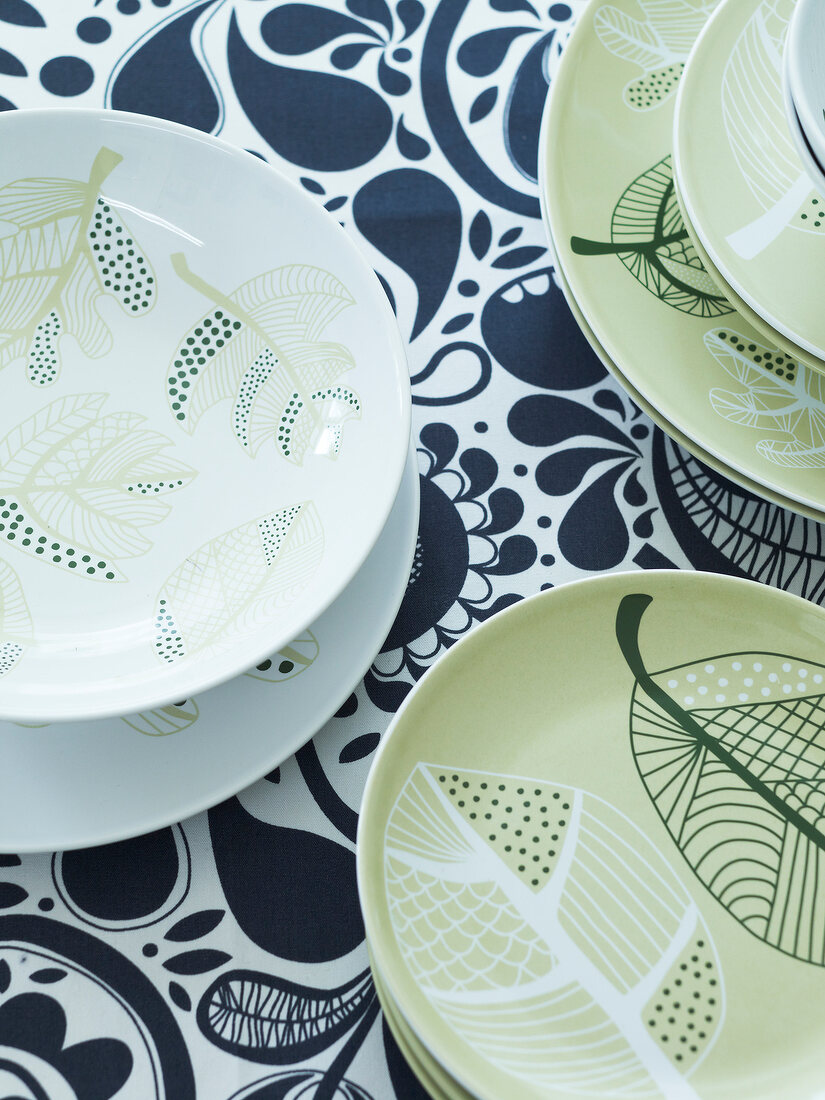 Close-up of patterned dishes on table runner