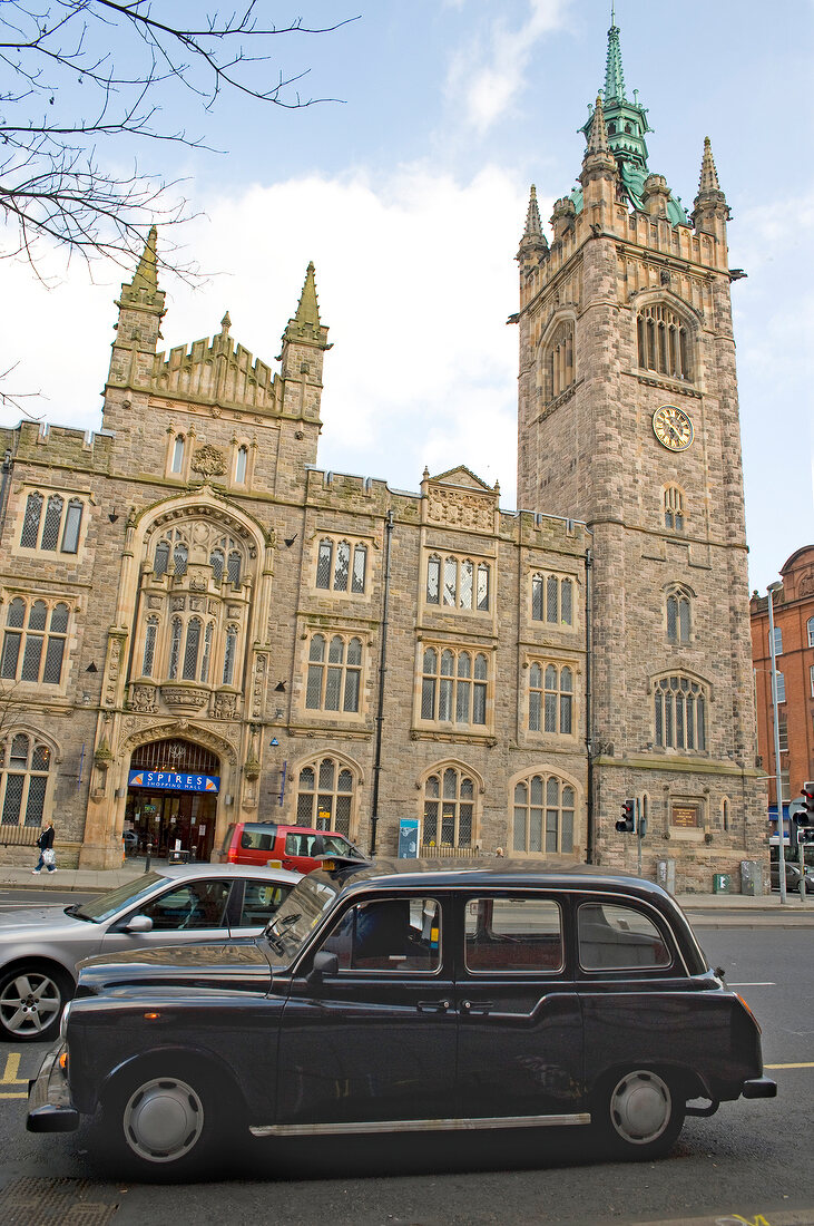 View of shopping mall with spires and vehicles on street at Belfast, Northern Ireland