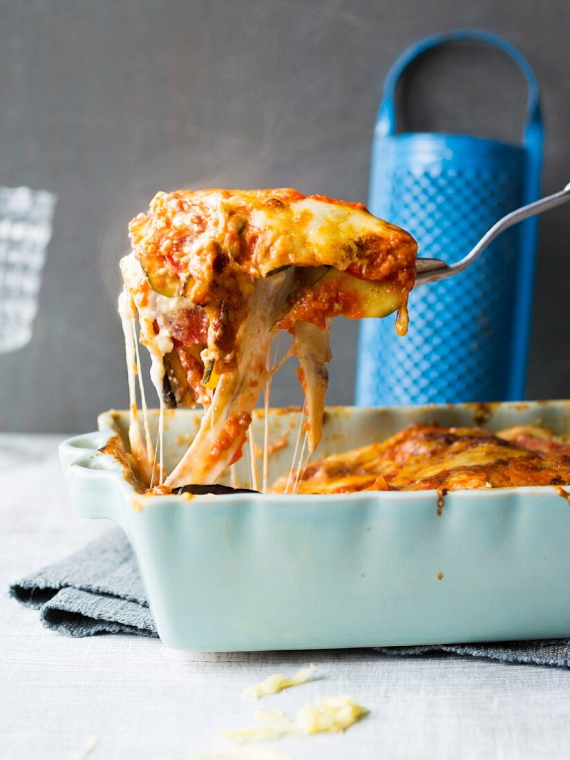 Lasagnea in a baking dish and on a spatula