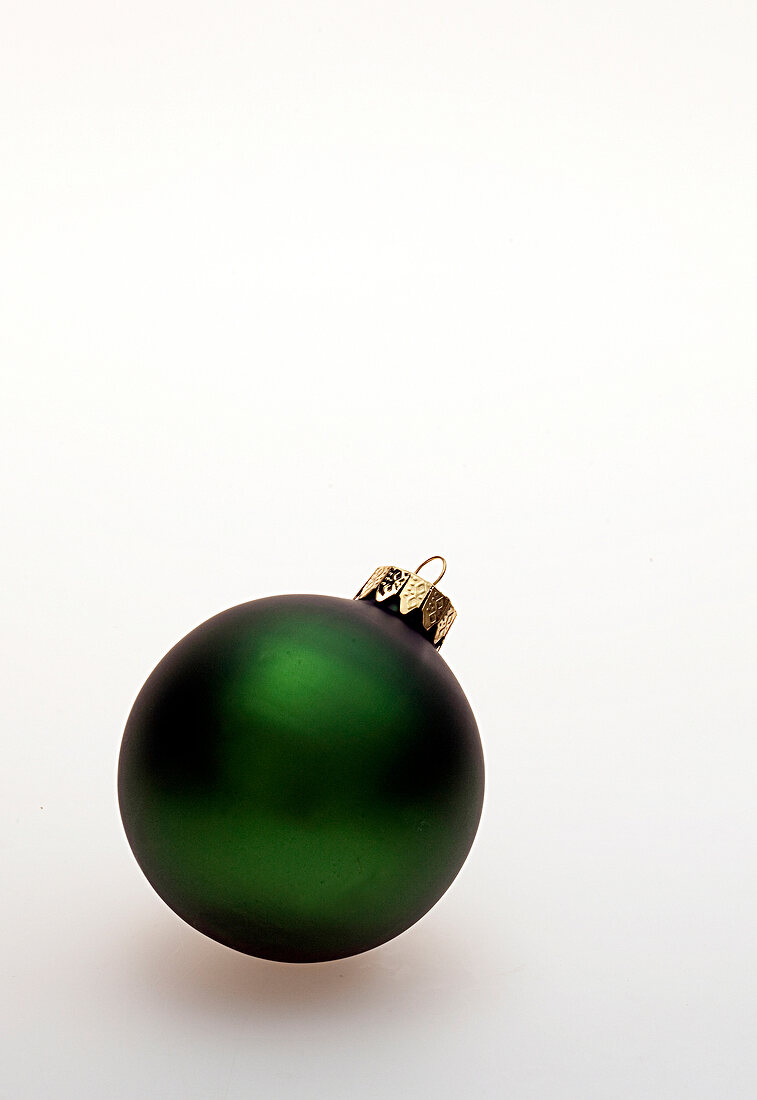 Close-up of green Christmas ball on white background
