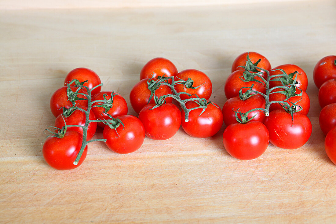 Red tomatoes on wooden background