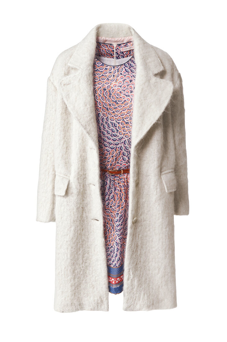 Woolen coat over patterned dress against white background