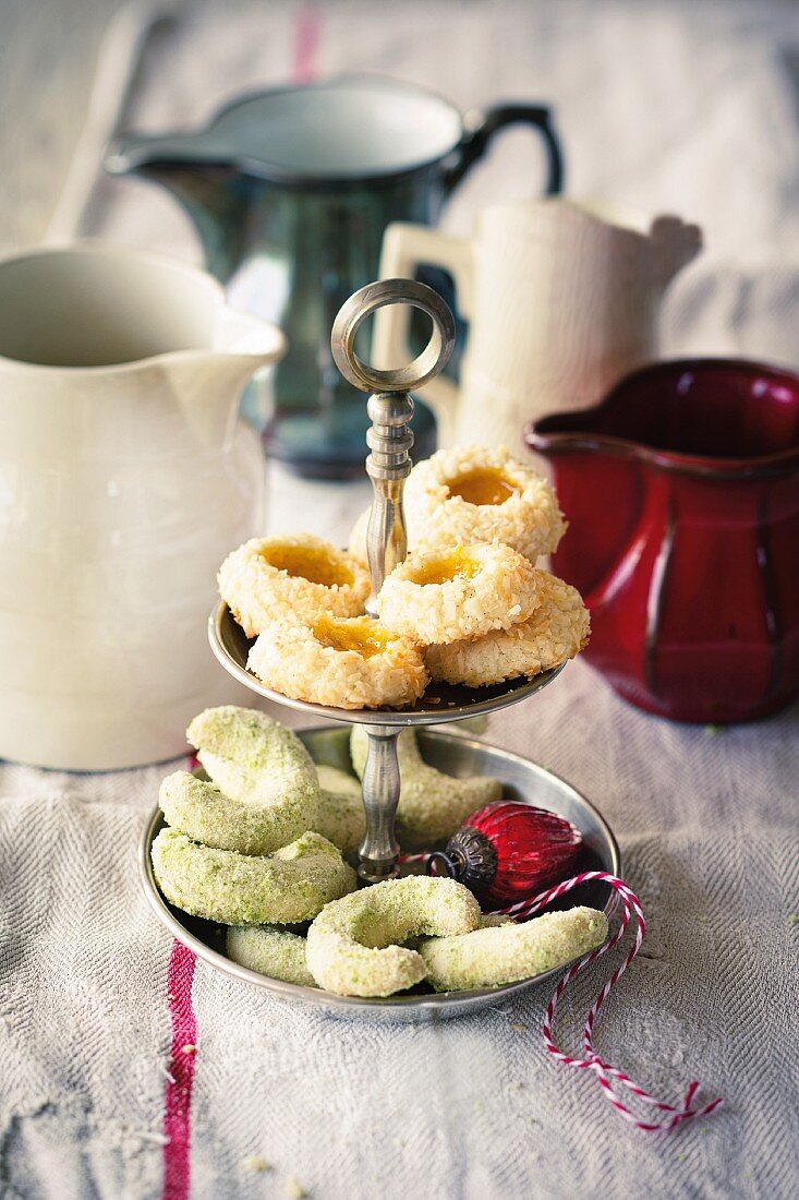 Mango doughnuts and cardamom and pistachio biscuits on a cake stand