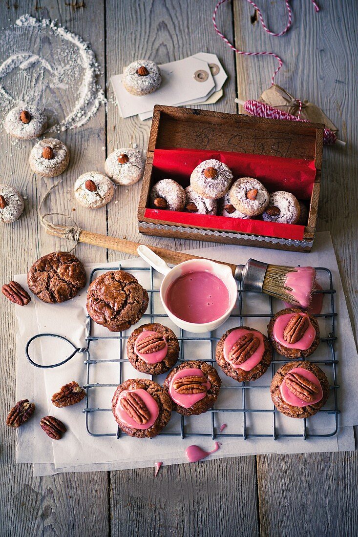 Almond biscuits and pecan nut biscuits with pink icing sugar
