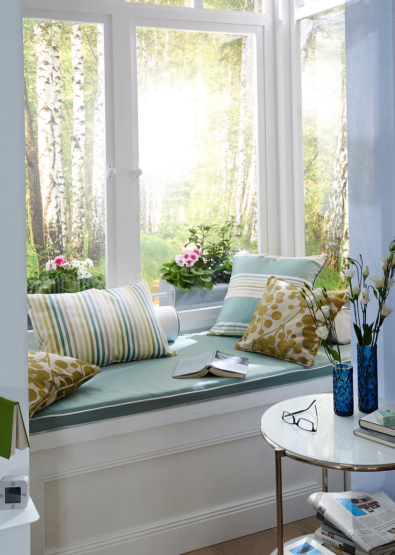 Close-up of window seating with various pillows