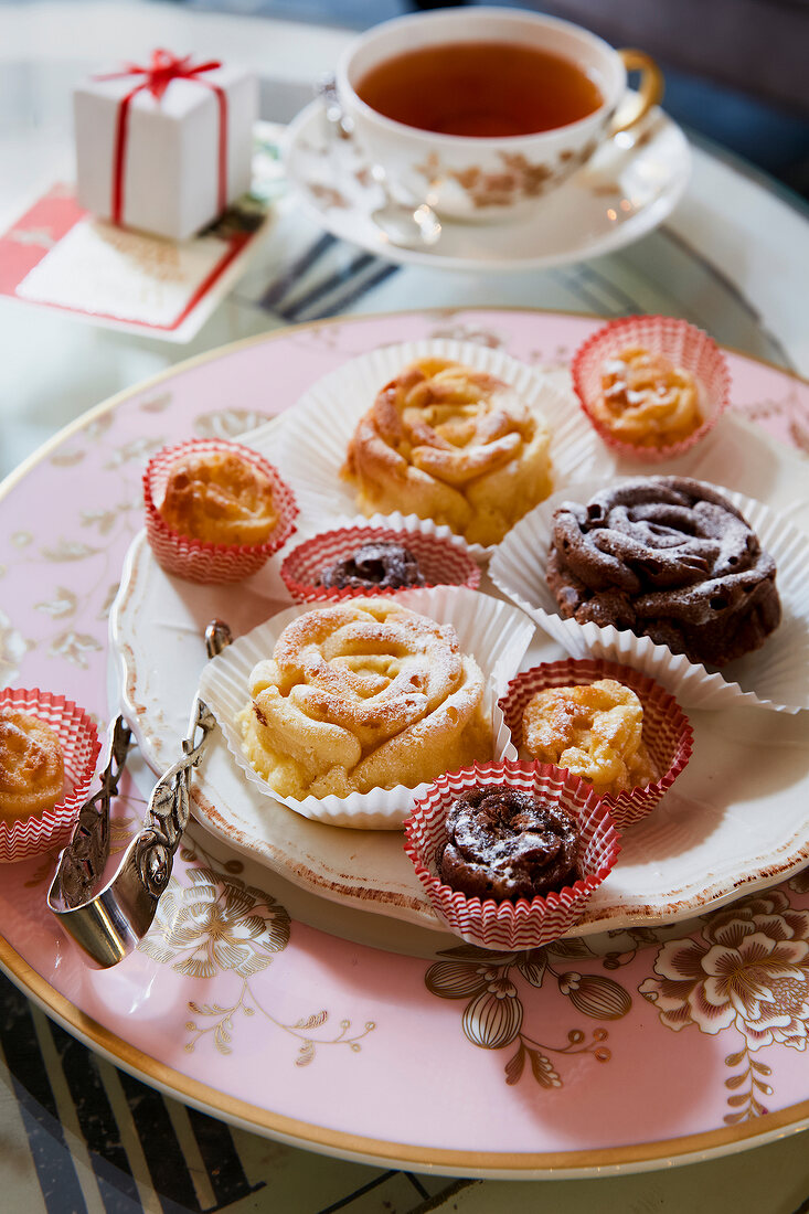 Rose shaped cookies in paper cases on plate