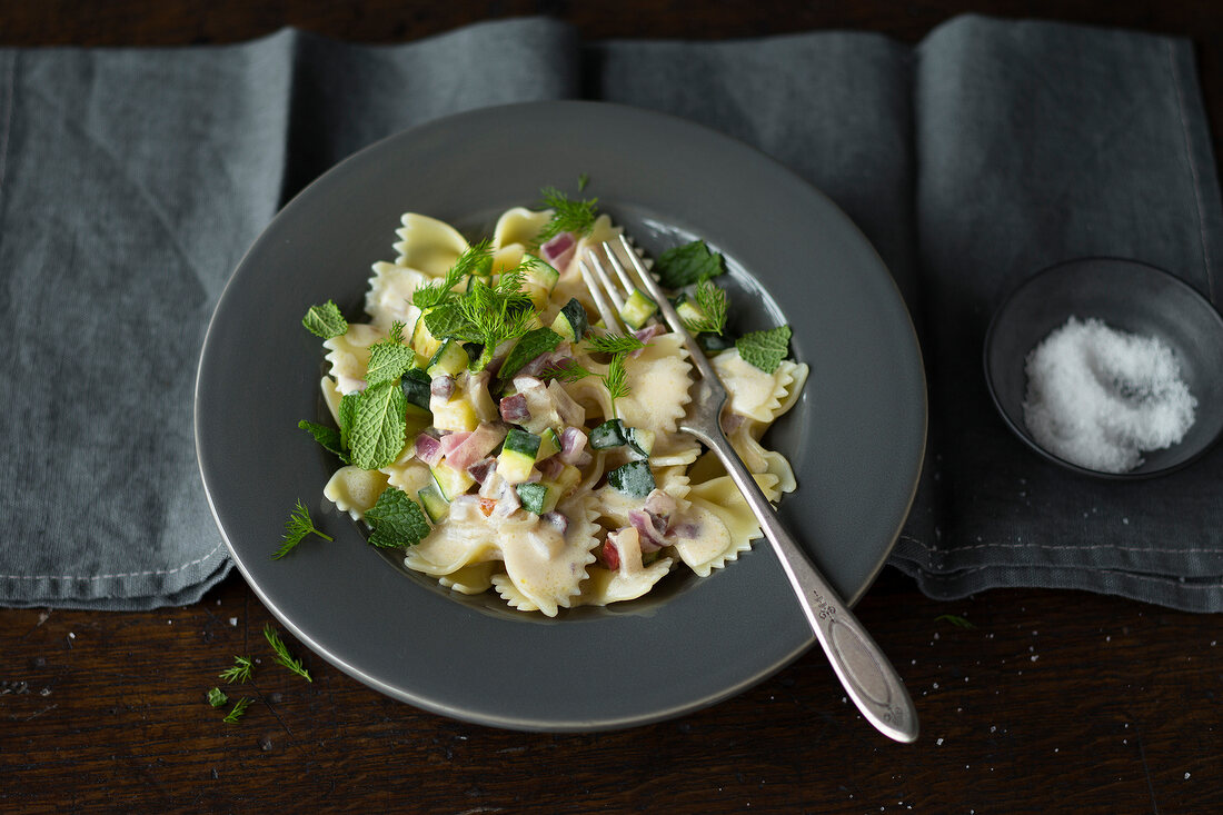 Farfalle with zucchini and goats cheese sauce on plate