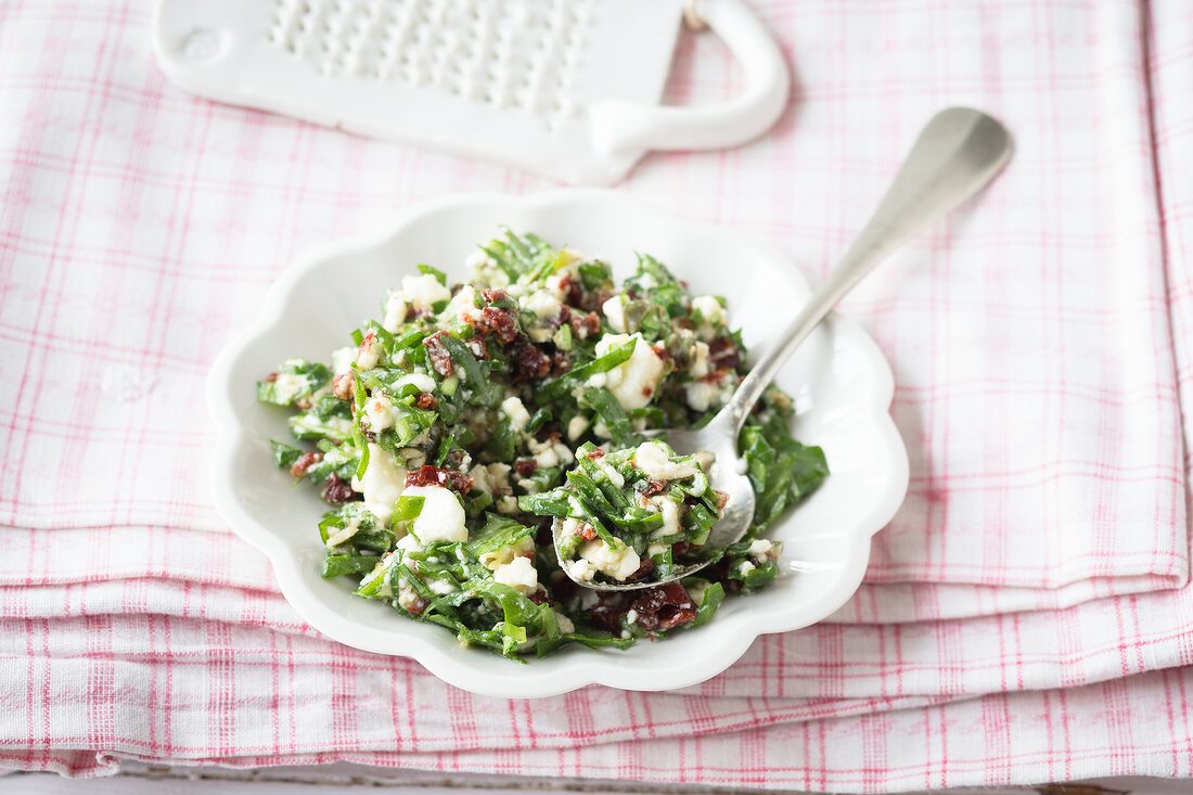 Rocket with feta and pesto sauce on plate