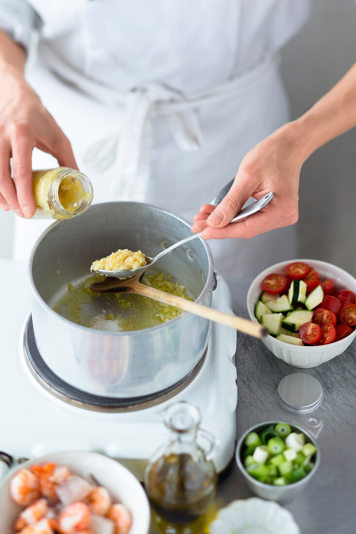 Close-up of chef cutting raw fish on chopping board