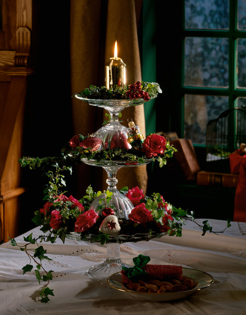 Christmas decoration on tiered stand with ivy and red roses