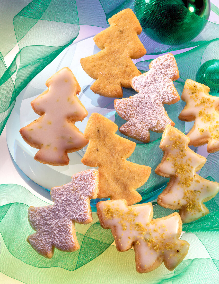 Close-up of pine tree shaped pistachio cookies on green ribbon