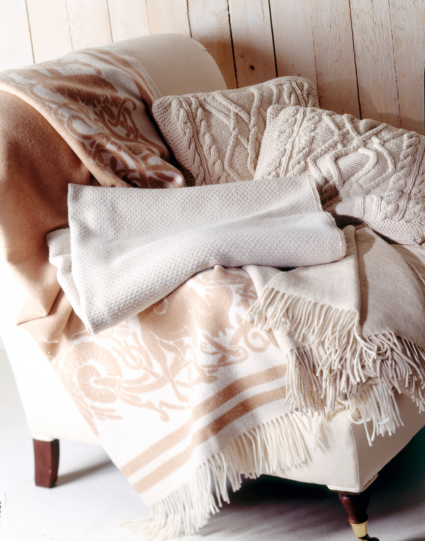 Beige coloured bed sheets on chair