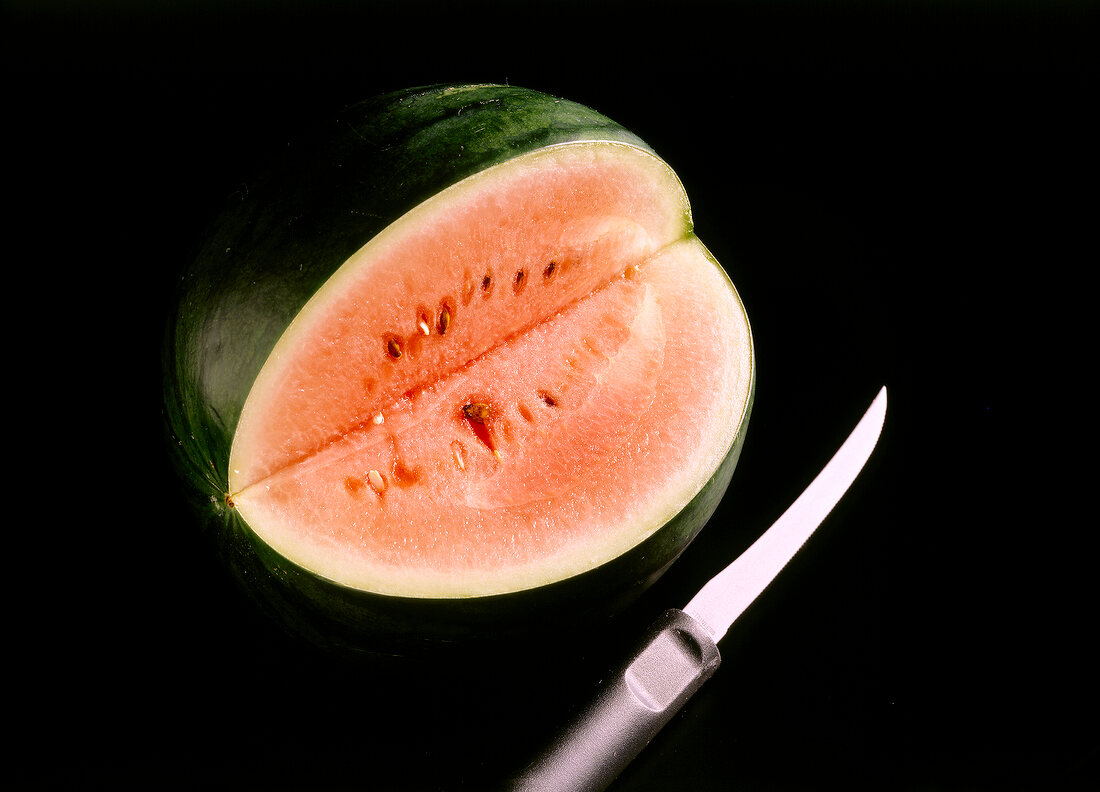 Half cut watermelon on black background