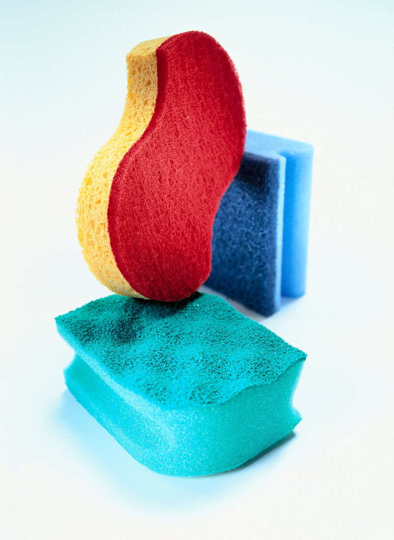 Close-up of colourful scrubbers on white background