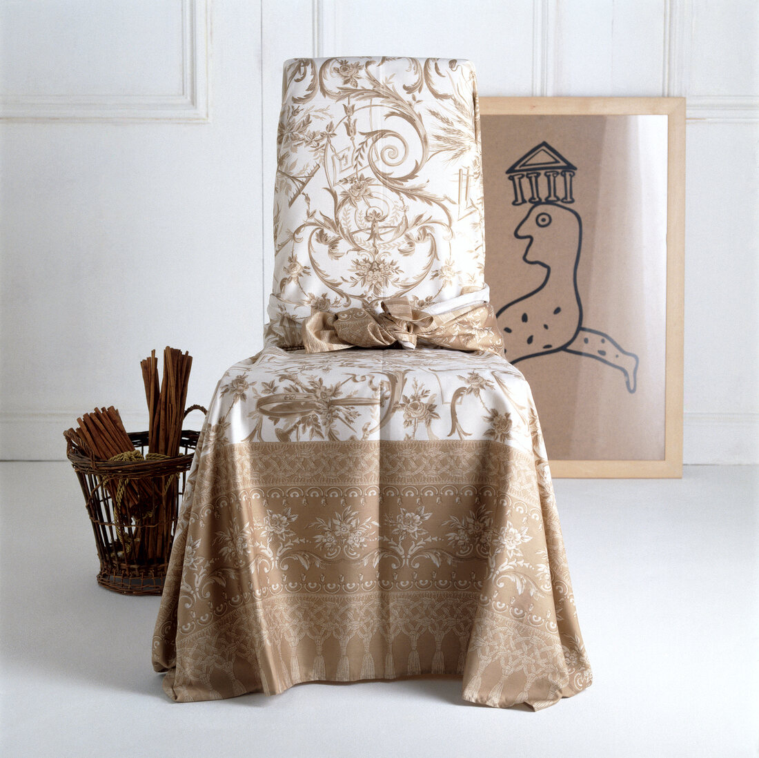Chair covered with beige and white coloured cover and basket by side