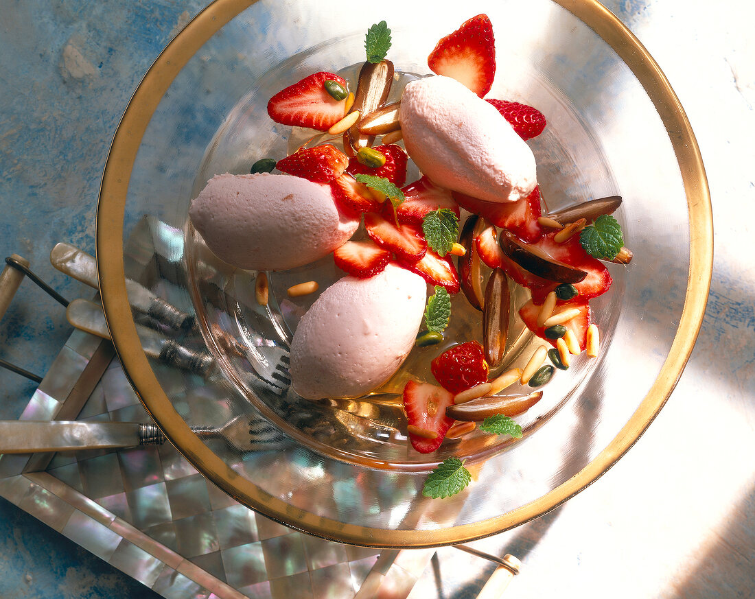 Close-up of hibiscus mousse with fresh fruit in glass bowl