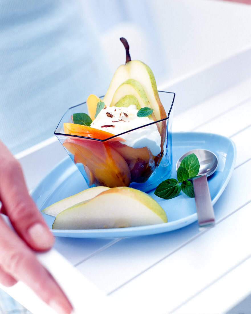 Pear and sharon fruit with yogurt cinnamon in bowl